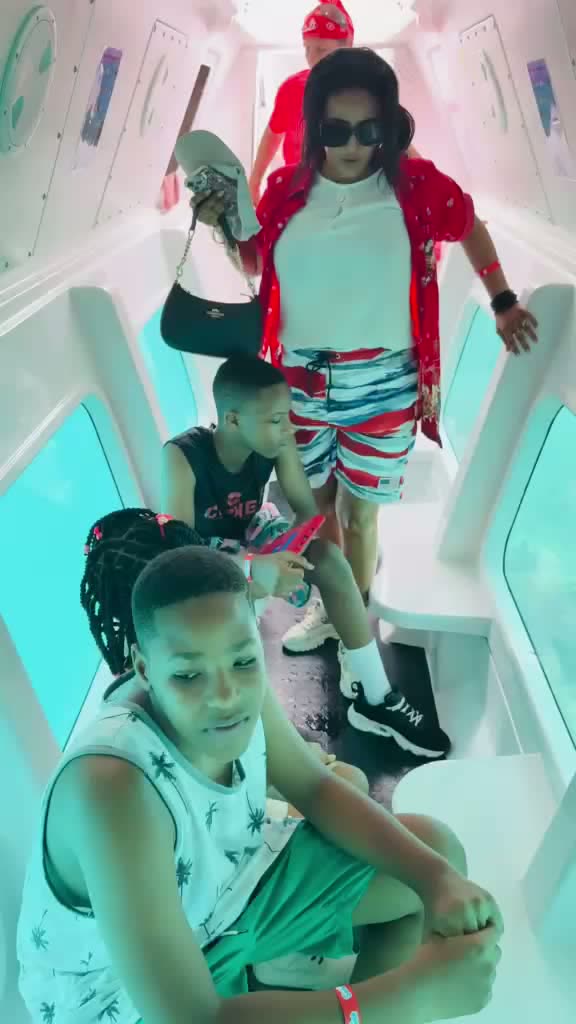 Family seated inside the air-conditioned semi-submarine viewing cabin during the expedition