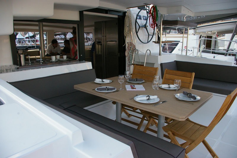 Set dining table in the catamaran's covered outdoor social area